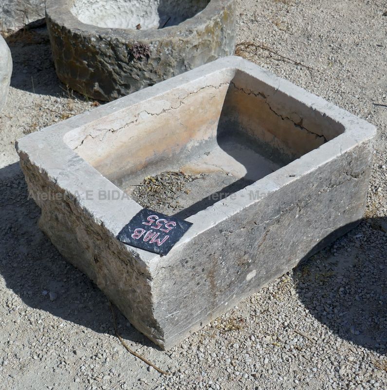 Antique stone trough weathered and worn by time : small rectangular trough in stone