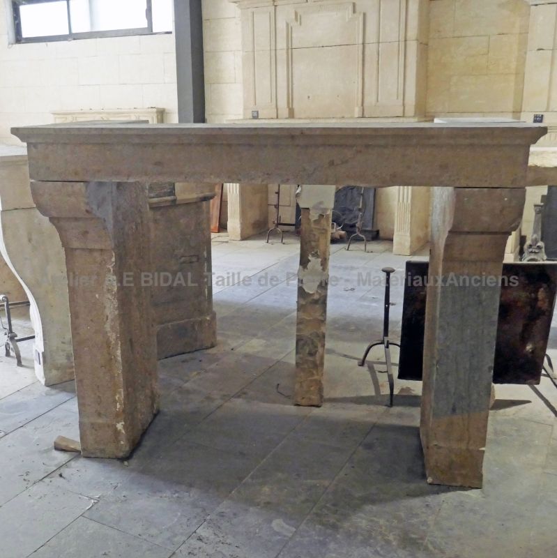 Antique fireplace in patinated Burgundy stone for sale in Provence at Atelier Alain BIDAL