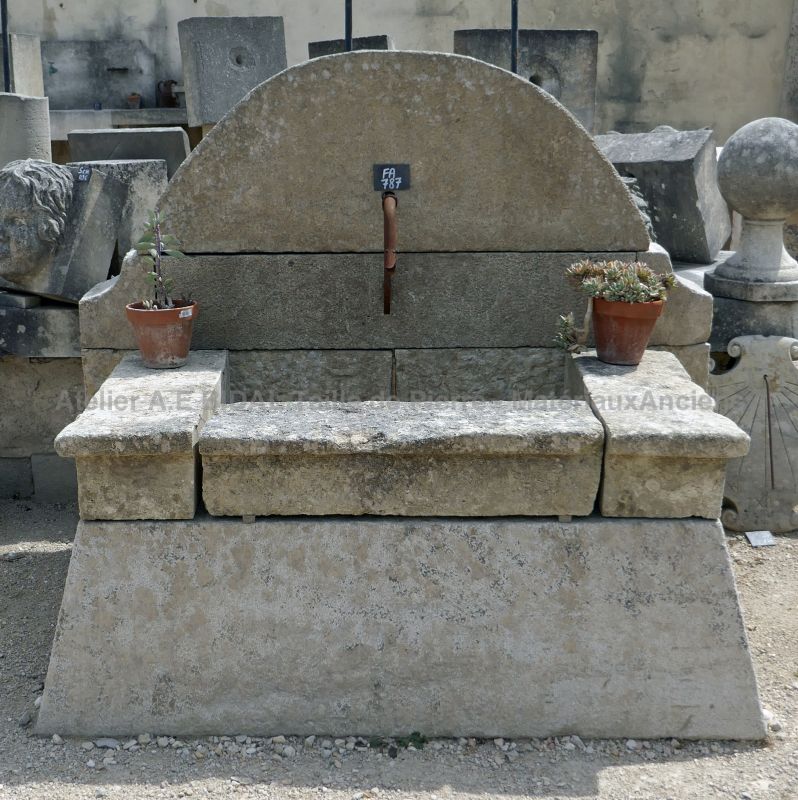 Wall fountain with a beautifully rounded pediment | Stone garden fountain for sale at Alain Bidal Antique Materials.