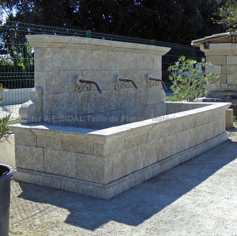 Large rustic fountain in weathered stones by the stonemason in Provence Alain BIDAL