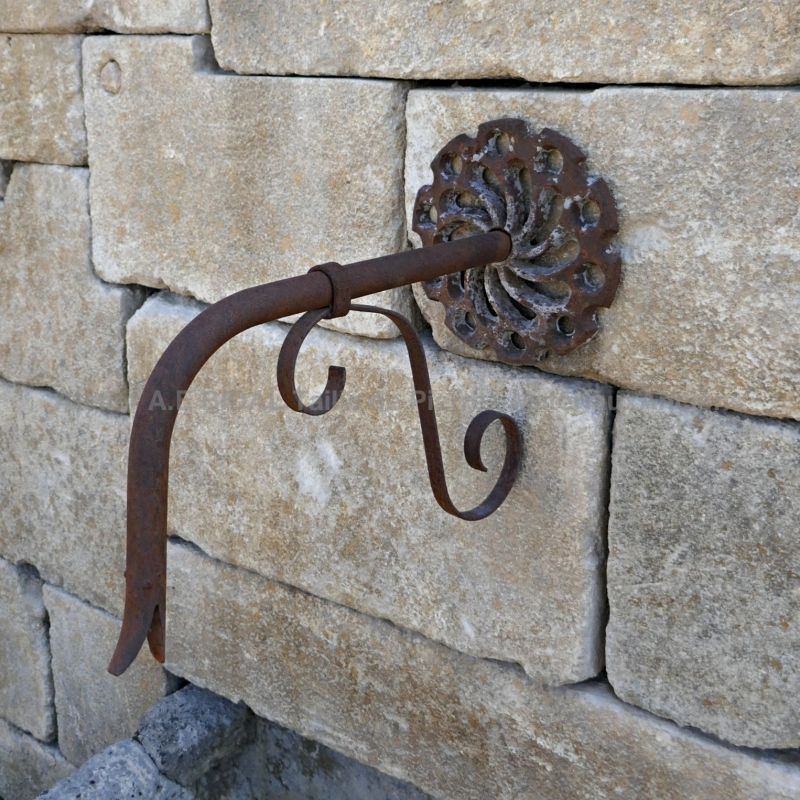 Detail of the antique wrought iron spout on our large garden fountain in stone and metal - Alain Bidal Antique Materials in Provence