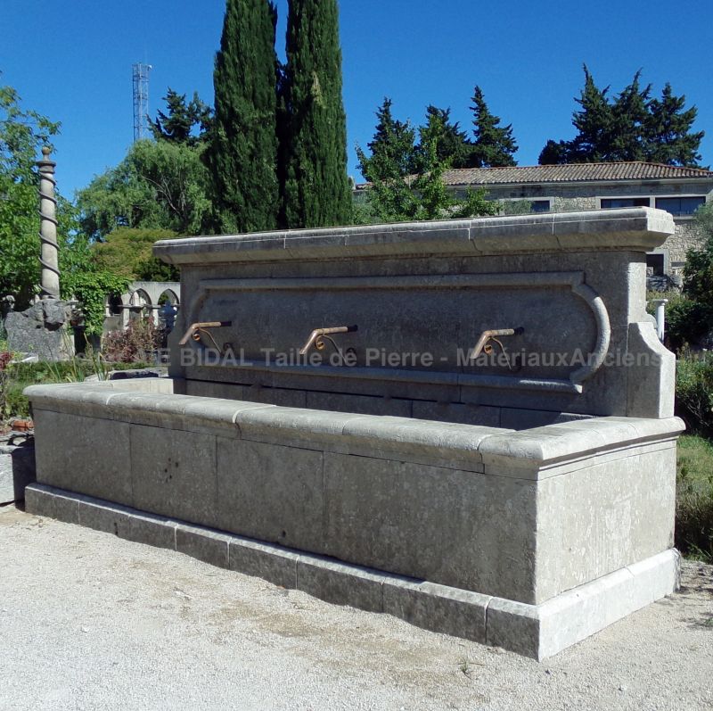 Large garden wall fountain in aged and patinated stones for sale at Alain BIDAL in Provence