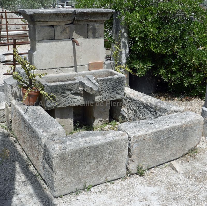 Detail of the stone pediment with water outlet, massive stone trough and spillway | Wall fountain for sale in Provence at Alain BIDAL
