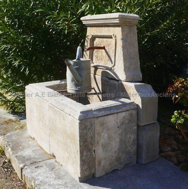 Country-style fountain in patinated natural stone : a wall fountain for sale in Provence at Alain BIDAL