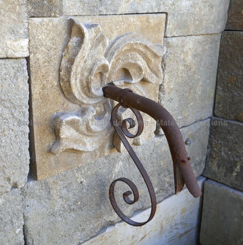 Gothic rose carved  in stone and water outlet in wrought iron - Fountain in ancient stones from Atelier Alain Bidal, Provence.