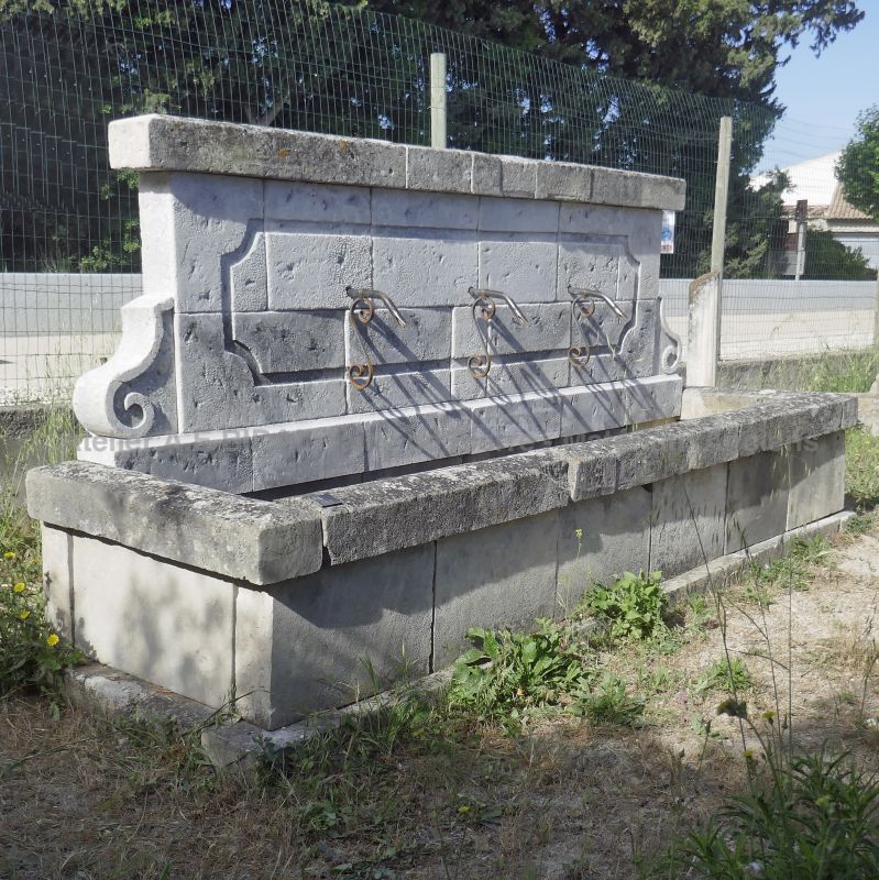 Charming rustic fountain in reclaimed old stone : a large wall fountain for sale in Provence