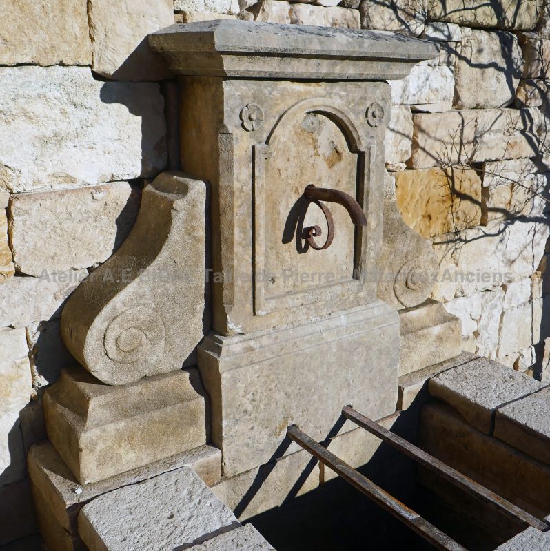 Charmingly Provencal fountain : a garden wall fountain in old stones by Atelier Alain BIDAL.