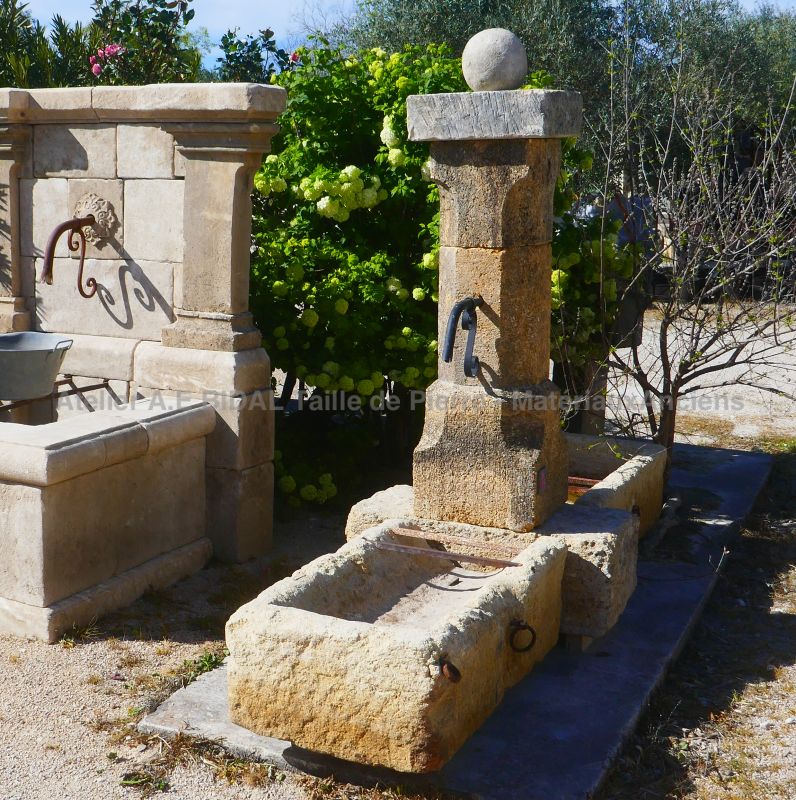 Central fountain in old stones : decorative fountain in weathered natural stones with 2 basins