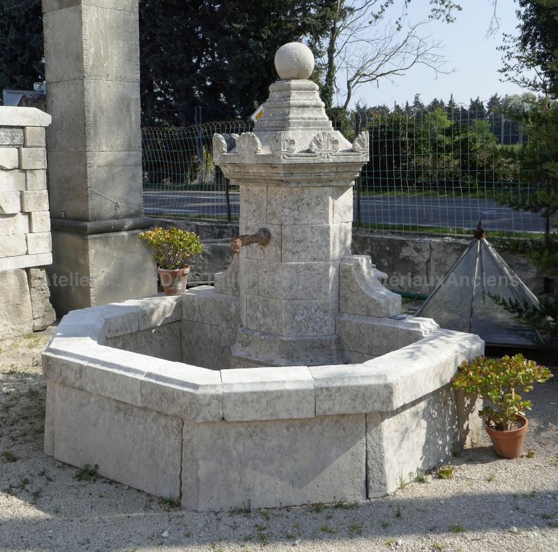 Decorative fountain in old stones to landscape your garden with style.