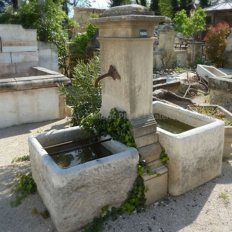 Outdoor fountain with a rustic charm | Old fountain made of natural stone for the decoration of the garden.