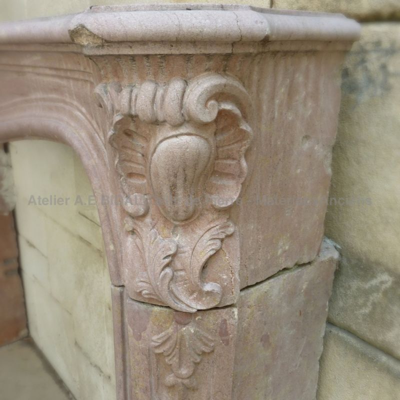 Antique French Regence fireplace with molded shelf in stone.