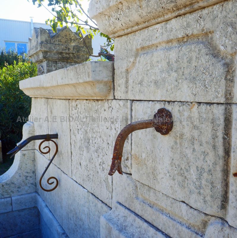 Stone pediment and wrought iron water spouts : Wall fountain by Alain BIDAL Antique Materials in Provence
