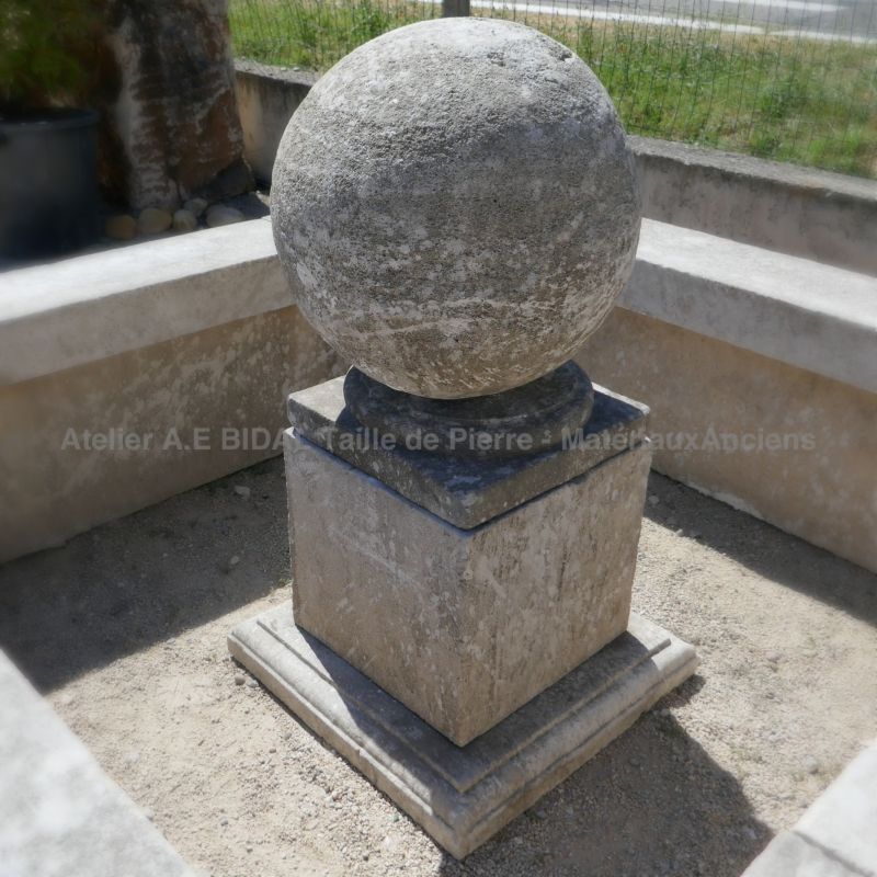 Detail of the central of our stone garden pond | Large stone ball and molded base.