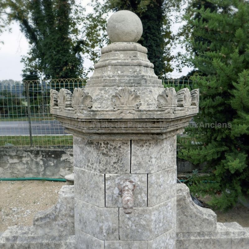 Detail of the fine sculptures carved by hand on the stone capital of our wall fountain.