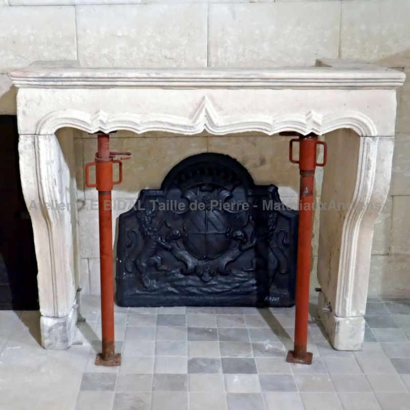 Large Louis XV stone fireplace for sale among a wide choice of antique mantels at Alain BIDAL.