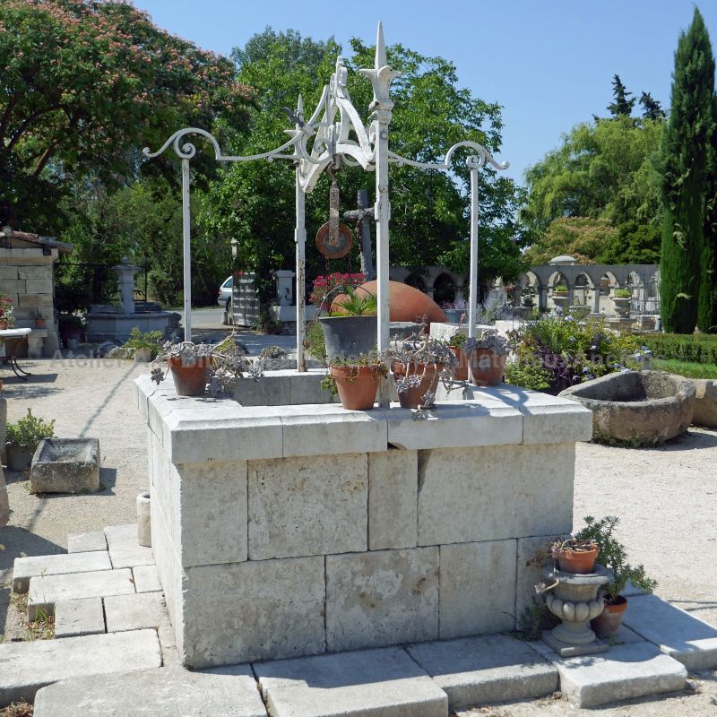 Decorative garden well made of old stones and wrought iron by Atelier Alain BIDAL