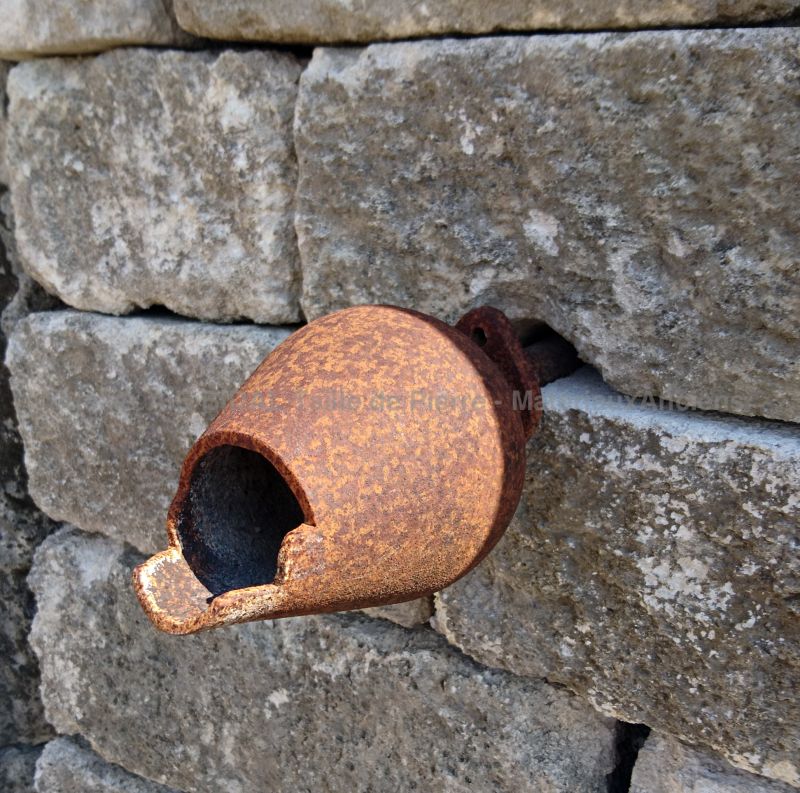 Detail of the antique wrought iron water outlet on our stone fountain with rounded pediment.