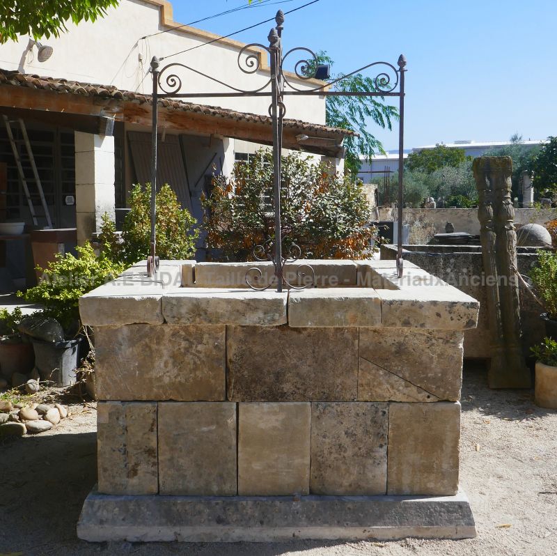 Stone and wrought iron well : Garden decoration by Atelier Alain Bidal in Provence