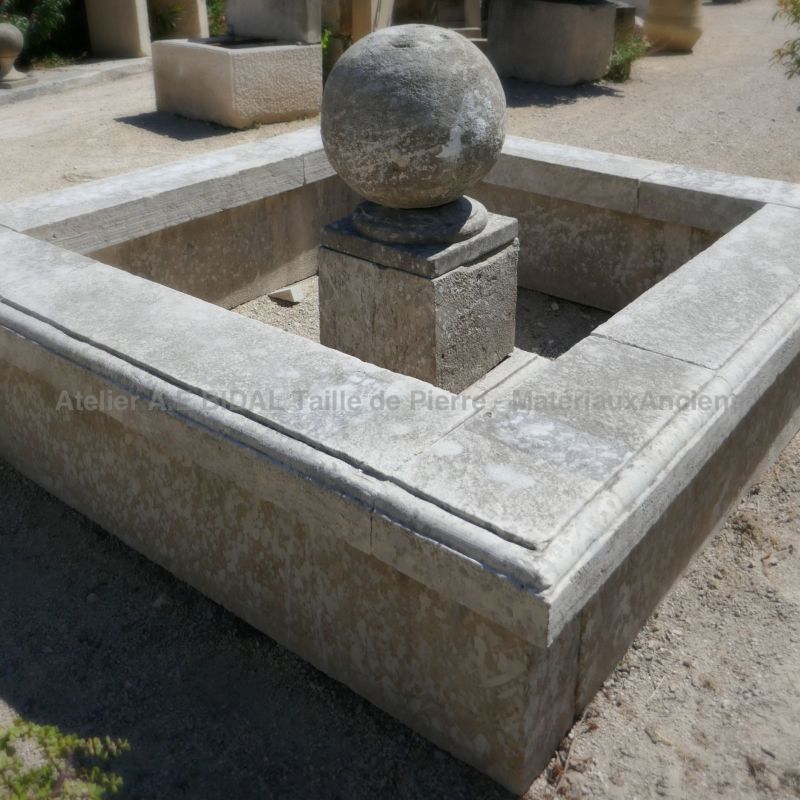 Garden fountain with stone ball | Square basin in old stones for garden landscaping.