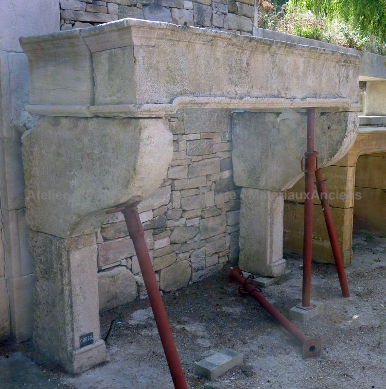 Large antique Louis XIV stone fireplace for sale at Atelier Alain BIDAL, Provence