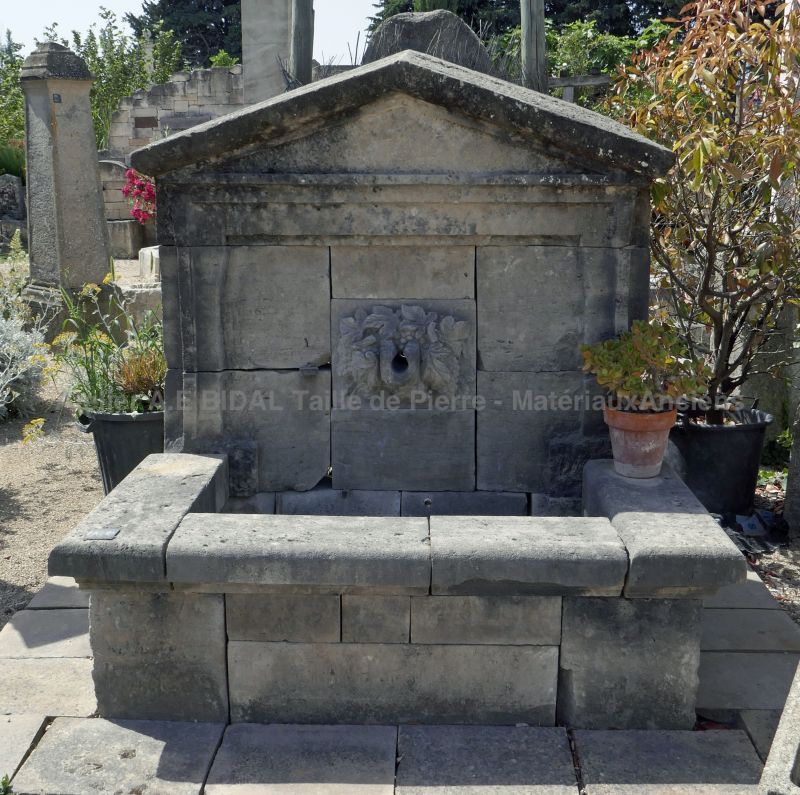 Outdoor fountain with carved basin and gargoyle | Large garden fountain made of natural ancient stones.