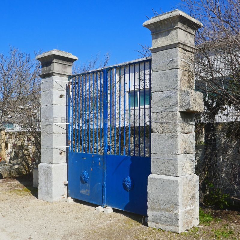 Reclaimed pillars in hard weathered stone - Pair of gate pillars by The Antique Materials in Provence Alain BIDAL