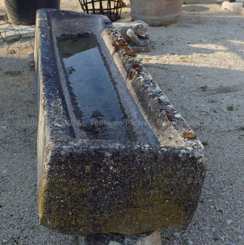 Long and shallow stone trough worn and patinated by time by Alain BIDAL Antique Materials in Provence