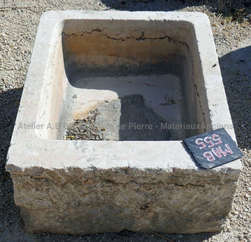 Old hard stone trough weathered and worn by time : small rectangular trough in stone