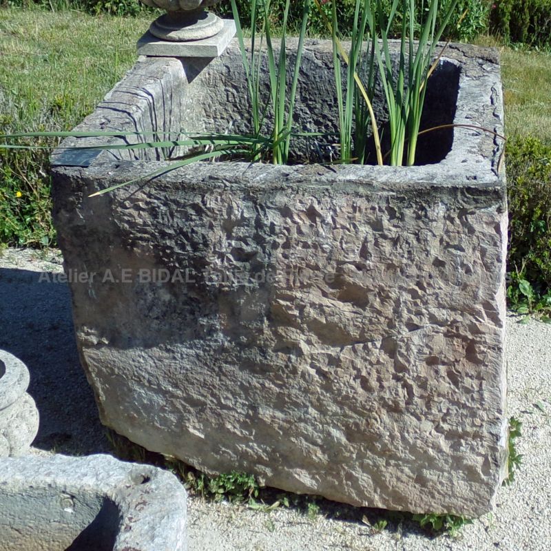 Antique trough in stone ideal for a rustic and robust planter on sale at Alain BIDAL Antique Materials in Provence