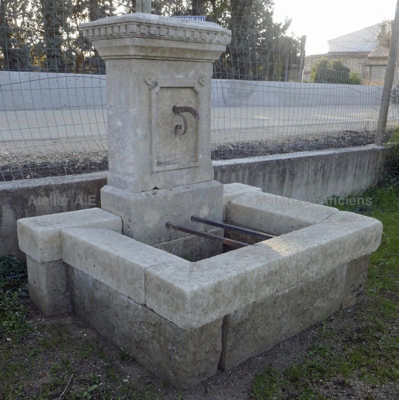 Weathered stone wall fountain : a small fountain with the rustic charm of yesteryear