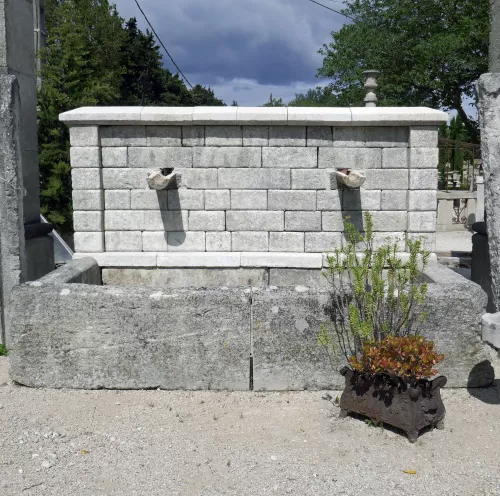 Ancienne fontaine murale en pierre pour l'aménagement et la décoration du jardin.