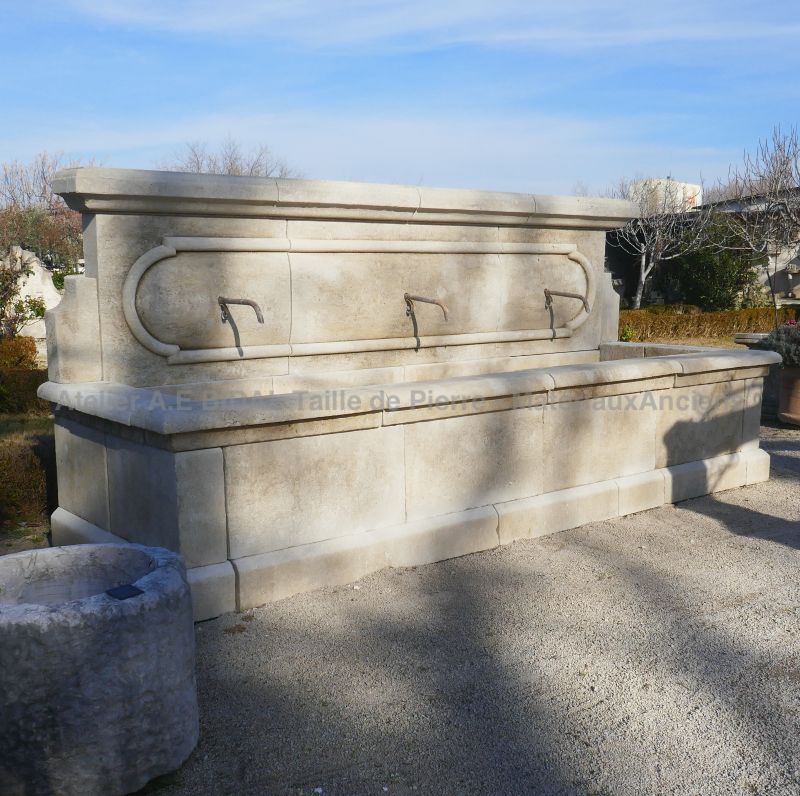 Large garden wall fountain in patinated stones for sale at Atelier Alain BIDAL (Provence)