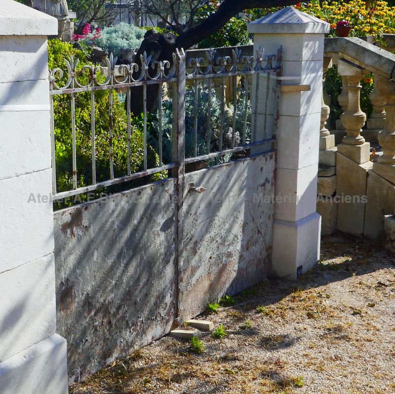 Old wrought iron gate - old gate of rustic appearance for the entrance of a property