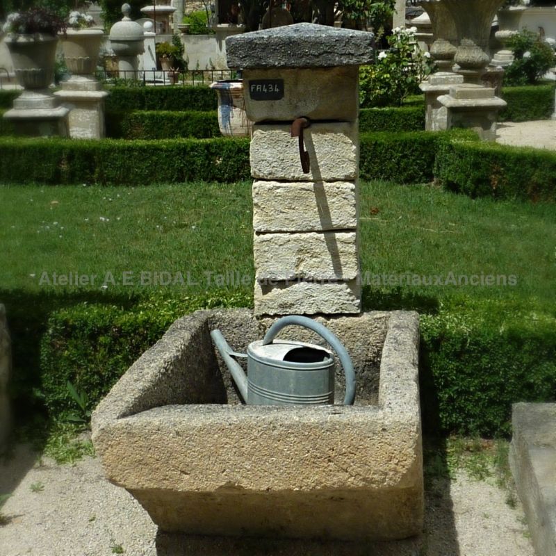 Outdoor fountain with old stone trough | Small wall fountain to create a charming water point in a garden | Provence fountain made of old stone.