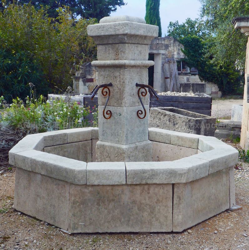 Rustic-looking central fountain in reclaimed old stones by Les Matériaux Anciens en Provence Alain BIDAL