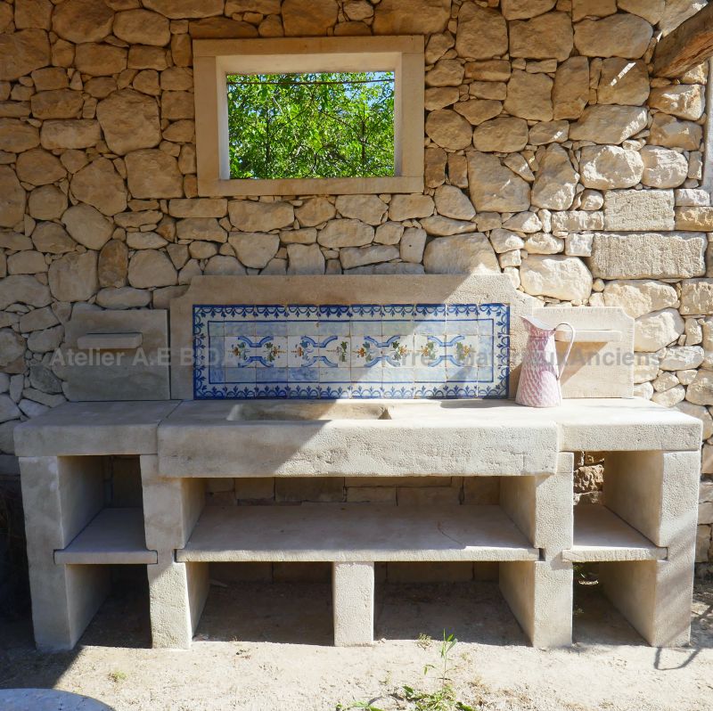 Summer kitchen in patinated stones by Alain Bidal Antique Materials in Provence
