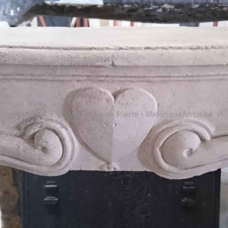 Antique stone fireplace called wedding - Antique fireplace decorated with a sculpted heart.