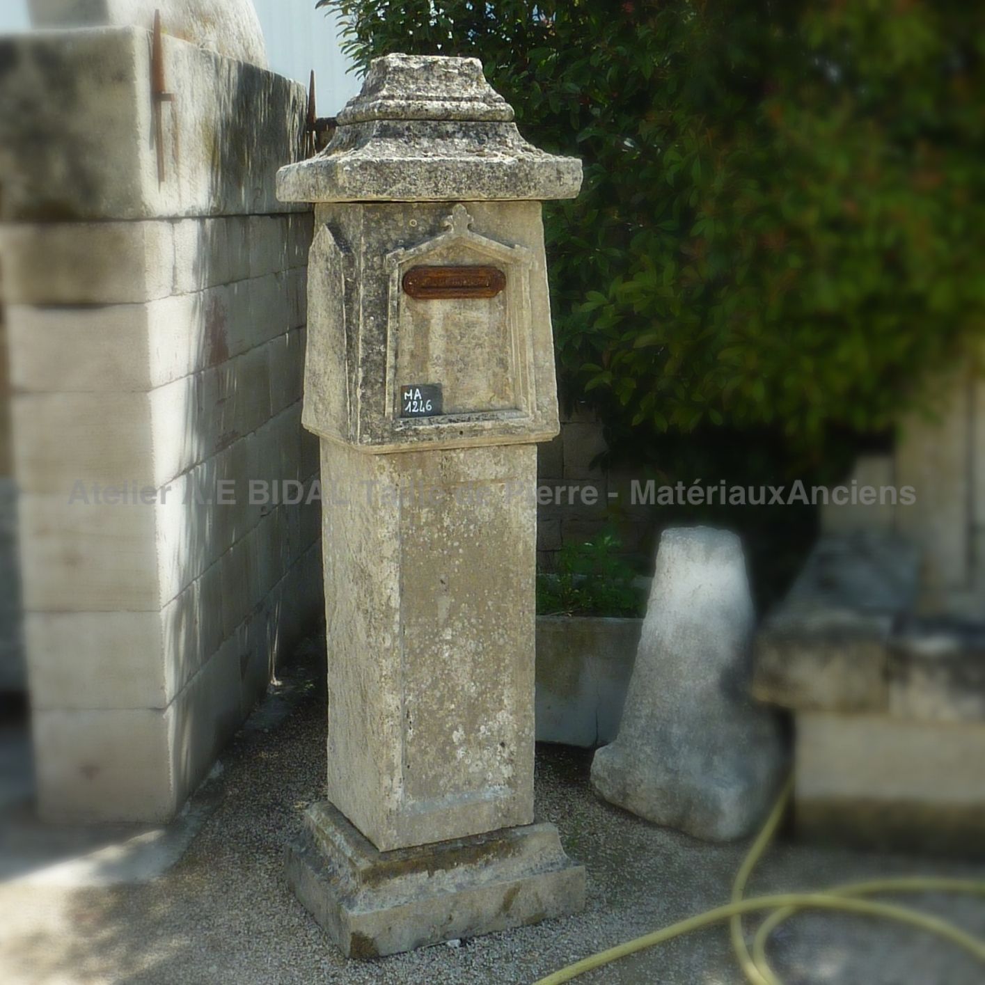 Mailbox made of old materials - made of stone with metal front plate.