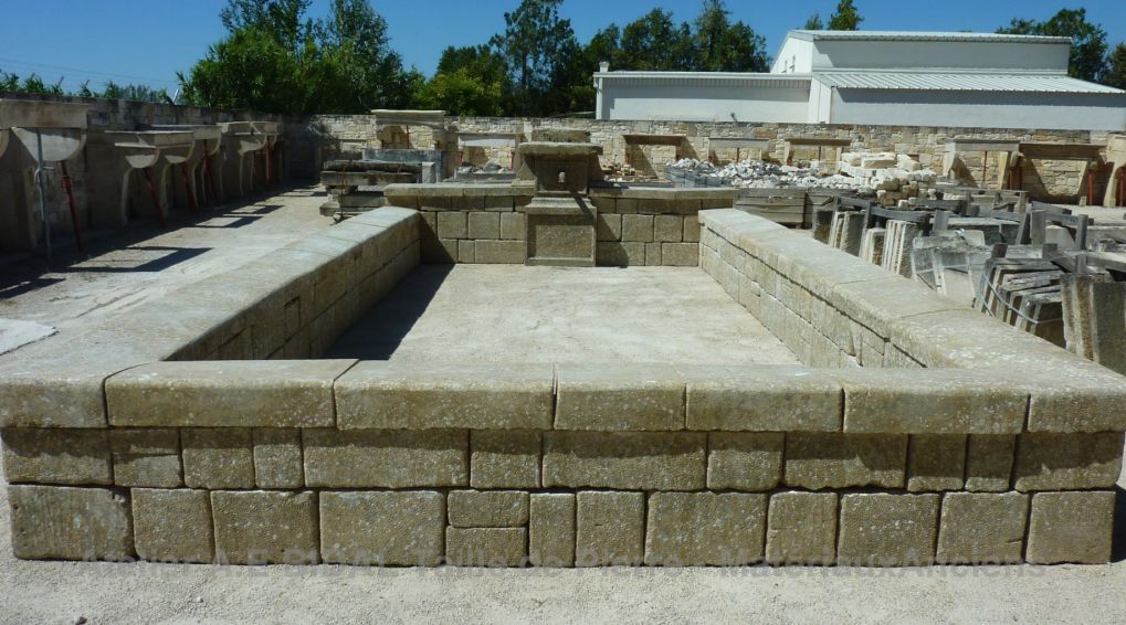 Old wash house with a large rectangular basin and a smaller basin in stone.