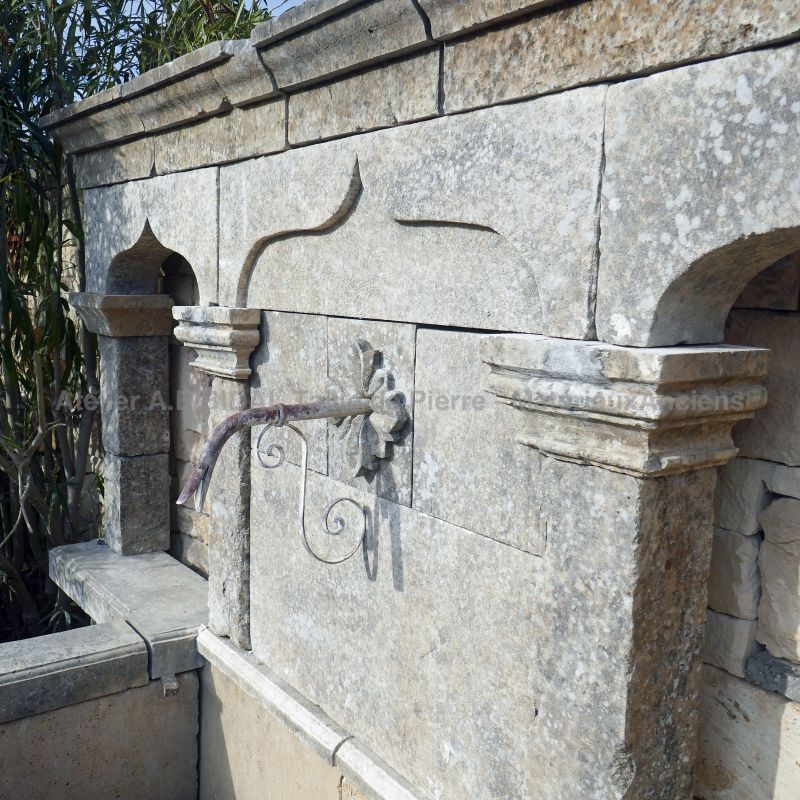 Detail of the carved pediment on our large wall fountain in weathered stones : Atelier Alain BIDAL (Provence)