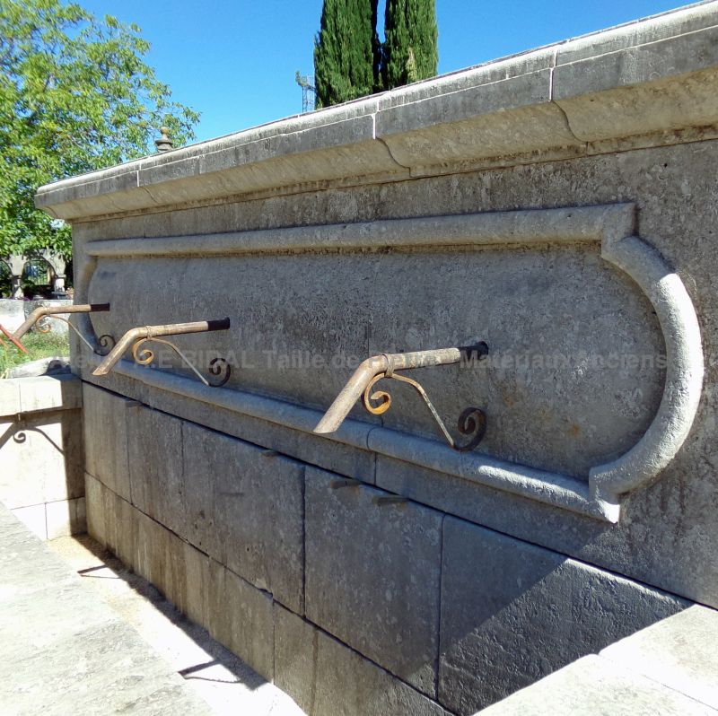 Detail of the 3 antique wrought iron water spouts on the pediment of our large fountain wall crafted in natural stones