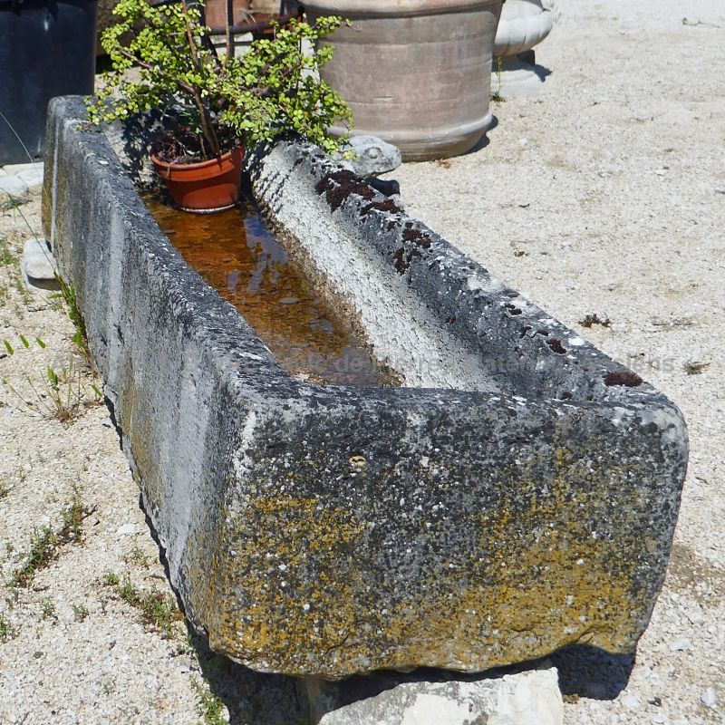 Long and shallow rustic-looking trough in aged stone to discover in Provence at Atelier Alain BIDAL