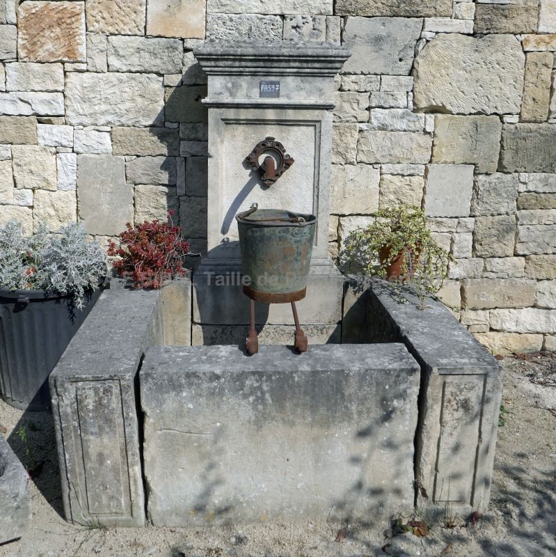 Beautiful wall fountain made of natural stone, a crafted fountain.