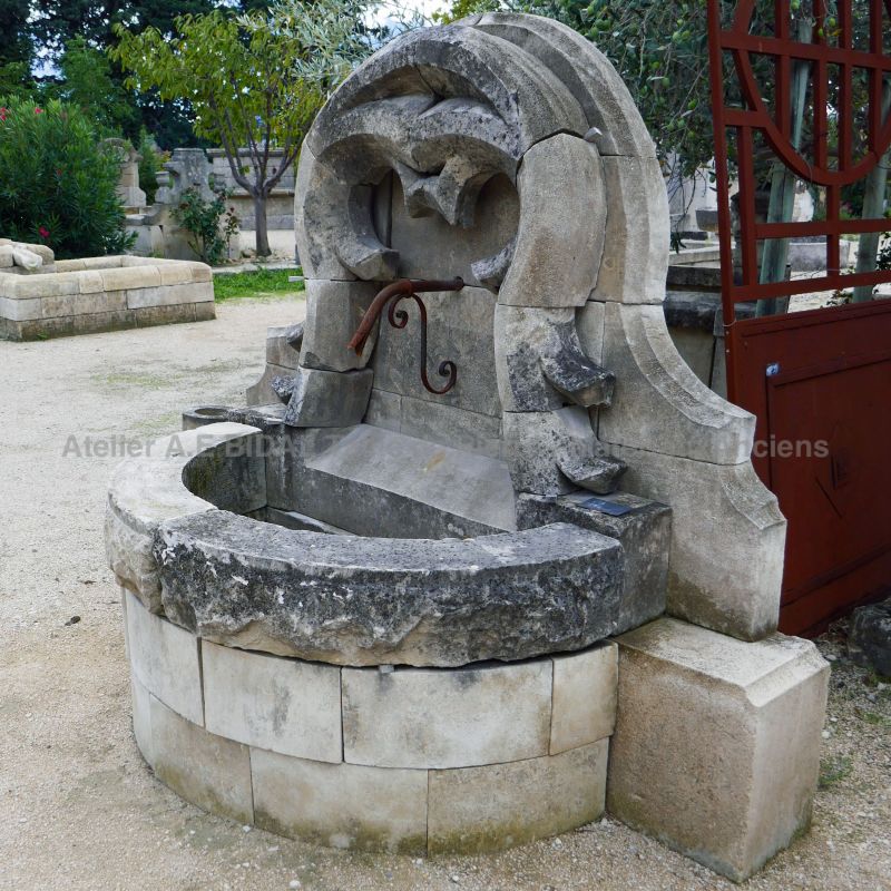Gothic fountain in aged stone | Stone wall fountain for landscaping your garden | Garden fountain, a beautiful creation of Alain Bidal in Provence.