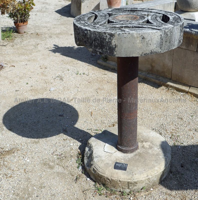 Antique table in a pedestal table style, made of old materials: stone, iron and old cast iron.