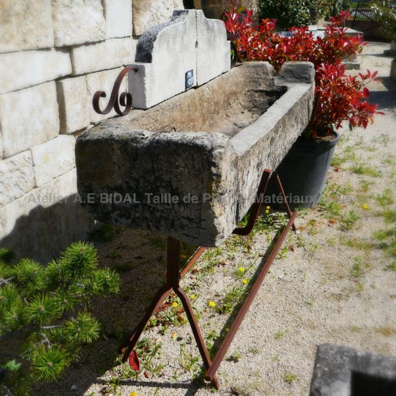 Antique stone trough | Outdoor stone sink ornated with wrought iron signed Atelier BIDAL.