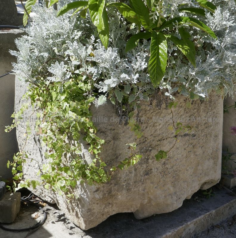 Antique worn and weathered stone trough on sale at Alain BIDAL Antique Materials in Provence.