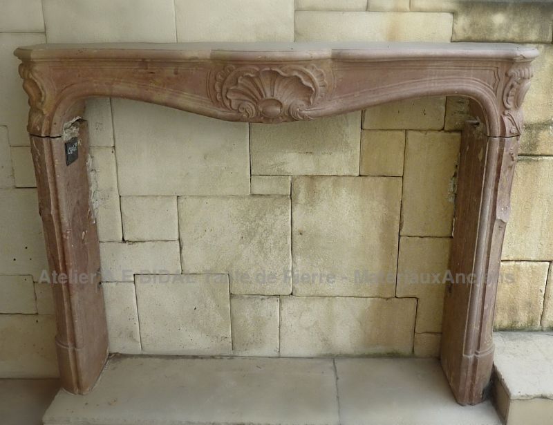 Antique stone fireplace - A pink stone mantle.