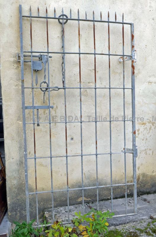 Old cellar door in grey-painted metal by The Antique Materials in Provence Alain BIDAL.