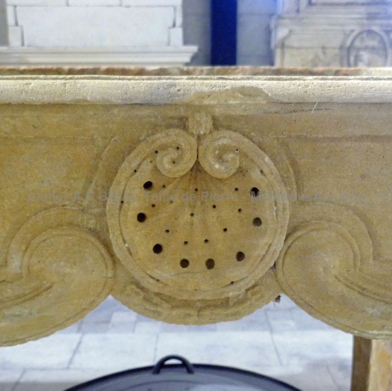 Antique Louis XV style golden stone fireplace for sale at Alain Bidal Antique Materials in Provence